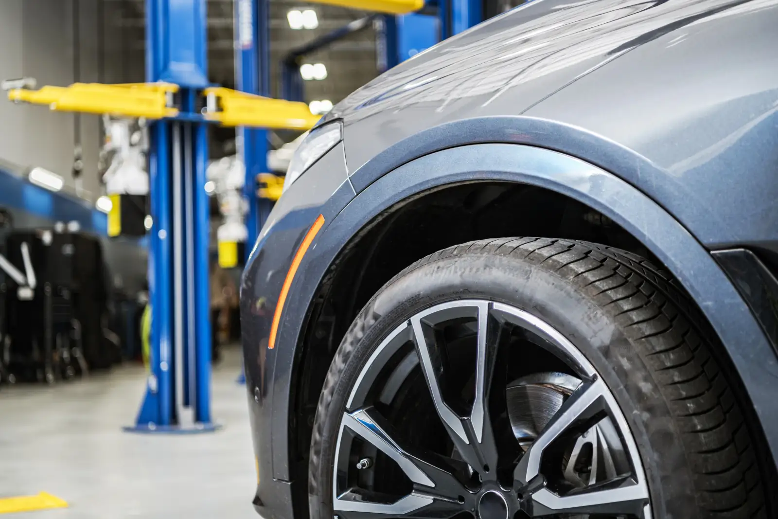 Professional AutoChain workshop with car undergoing service, showcasing modern automotive maintenance facility