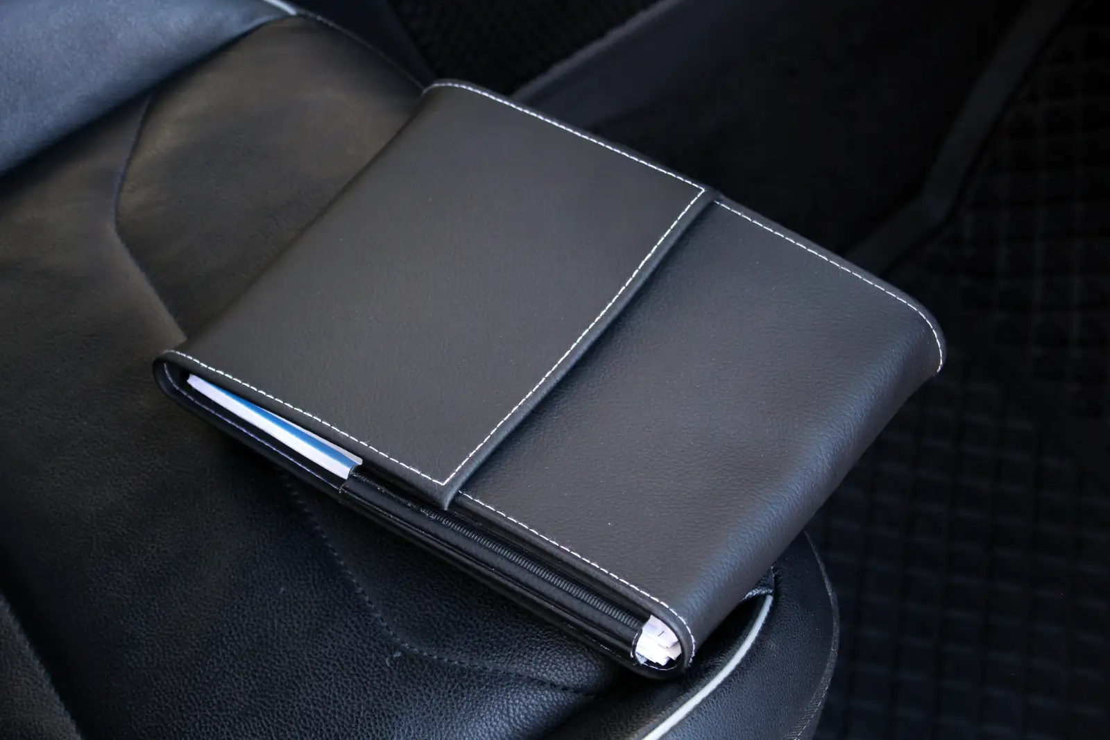 Check car service history - professional mechanic reviewing vehicle service records